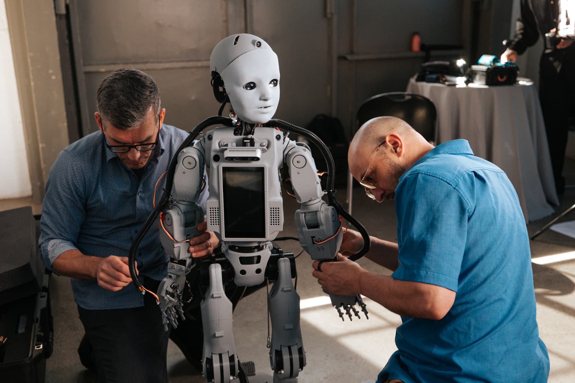 Two engineers assembling Codey in the Mind Children lab